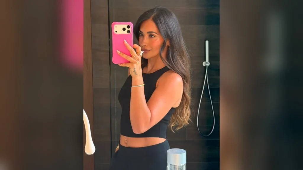Antonela Roccuzzo se hace un selfie ante el espejo con top negro y móvil de funda rosa