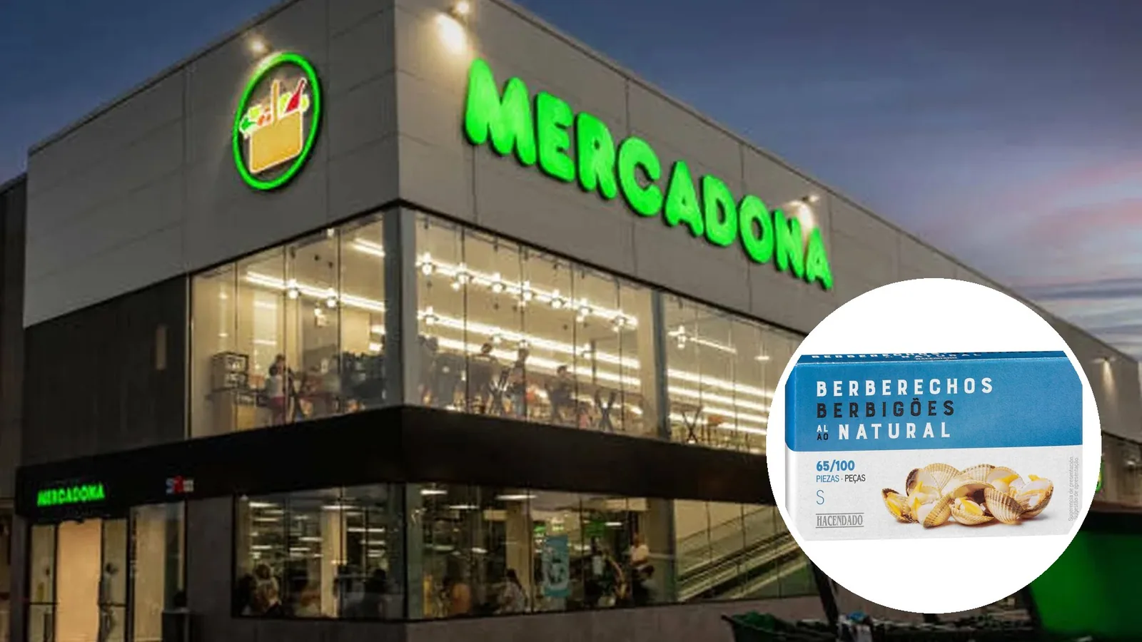 Fachada iluminada de un supermercado Mercadona con un círculo que muestra una lata de berberechos al natural Hacendado